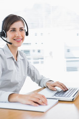 Happy call centre agent working at desk