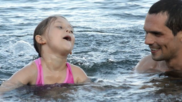 daughter swim with her father