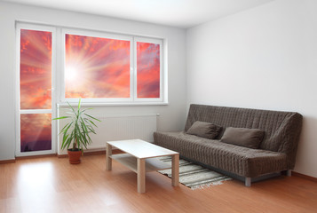 Living room interior with sunset view.