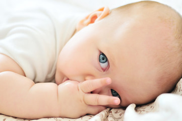 baby with finger in mouth