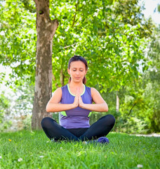 Woman exercising yoga in park