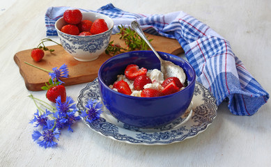 Summer still life with a strawberry and corn-flowers
