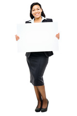 Happy mixed race business woman pointing at empty copy space iso