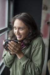 Young Woman with Beautiful Green Eyes Drinking Coffee