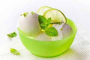 lemon sorbet decorated with lime slices and mint