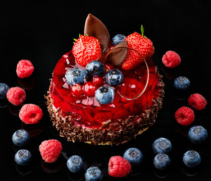 Cake with fresh berries and chocolate