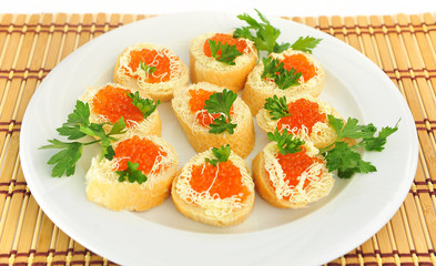 Plate with sandwiches with red caviar.