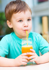 Little boy with glass of orange juice