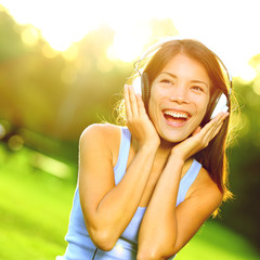 Woman listening to music in headphones singing