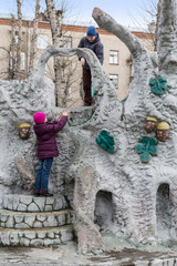 Boy and girl playing in playground with interesting fretwork.