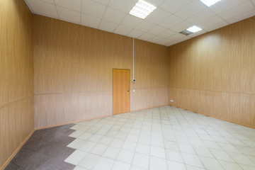 Large bright empty room with one door