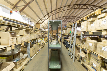 Large warehouse of sport equipment with lots of boxes