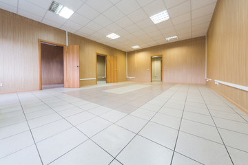Large bright empty room with three doors