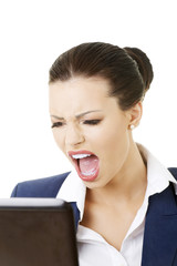 Angry businesswoman shouting on her laptop