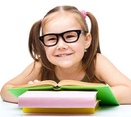 Little girl is reading a book