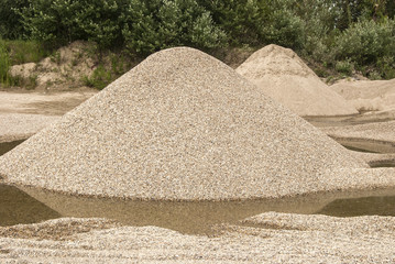 Piles of sorted gravel on industrial background