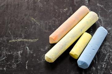 Colorful chalks on blackboard