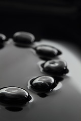 Black stones on calm water background