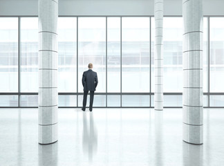 businessman standing in bright office