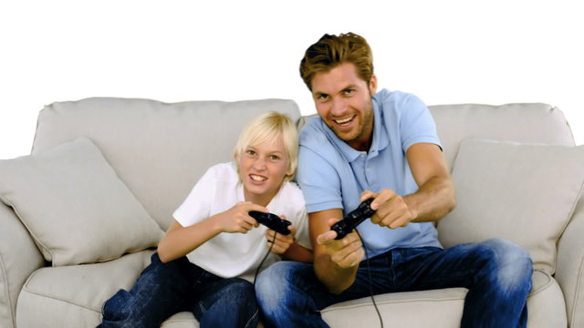 Father and son playing video games on white background