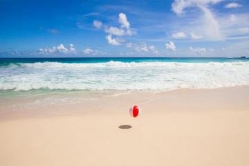 flying beach ball at the beach