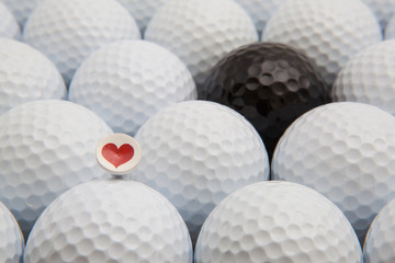 Different golf balls and romantic tee