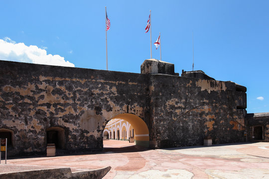 Flags fly above Fortification walls in El Morro