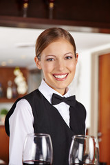 Kellnerin mit Weingläsern im Hotel