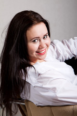 Portrait of long-haired woman in a white men's shirt