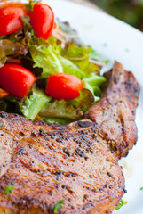 Pork chop with salad close up