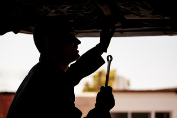 Silhouette of a mechanic at work