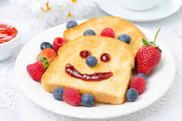 Breakfast with a smiling toast, fresh berries, berry jam