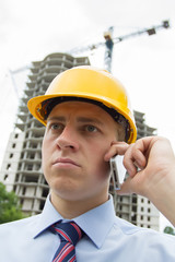 man in a hard hat talking on the phone