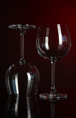 Two glasses on dark red background