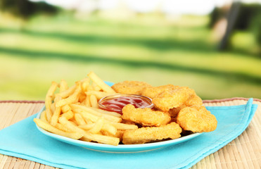 Fried chicken nuggets with french fries and sauce