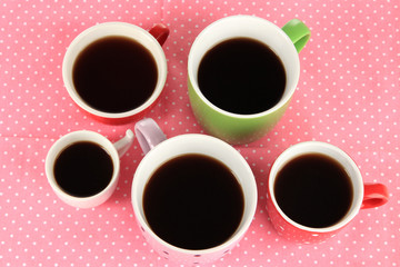 Cups of coffee on pink napkin