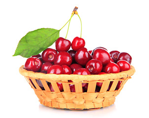 Cherry berries in wicker basket isolated on white