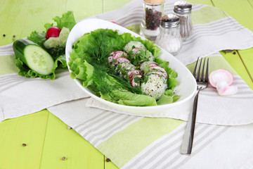 Vitamin vegetable salad in bowl on wooden table close-up