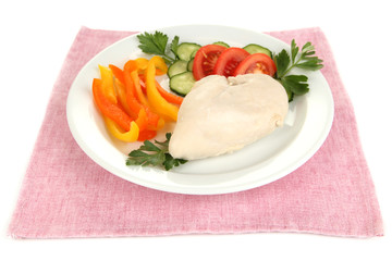 Boiled chicken breast on plate with vegetables close up