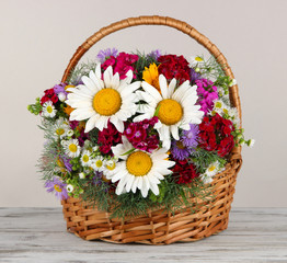 Fototapeta na wymiar Beautiful bright flowers in wicker basket