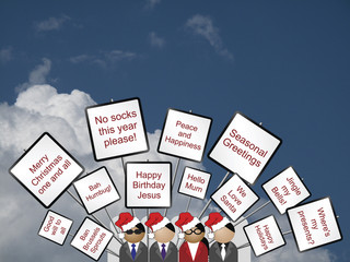 Crowd with placards with a Christmas theme