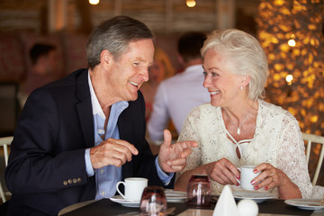 Senior Couple Enjoying Cup Of Coffee In Restaurant