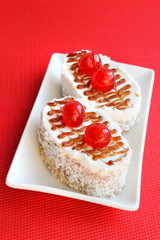 Cakes with biscuit, butter cream and coconut