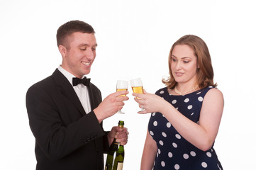 Happy couple celebrating with champagne - isolated on white