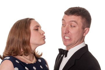 Man does not want kiss from woman - isolated on white