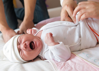 Obraz na płótnie Canvas Newborn baby crying on the bed, selective focus