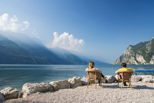man and woman sitting at the lake garda, italien