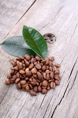 Coffee grains on grunge wooden background