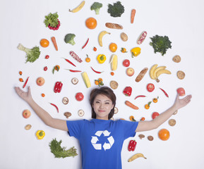 Young woman with fresh fruit and vegetables, studio shot