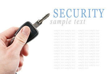 Hand holding car keys isolated on white